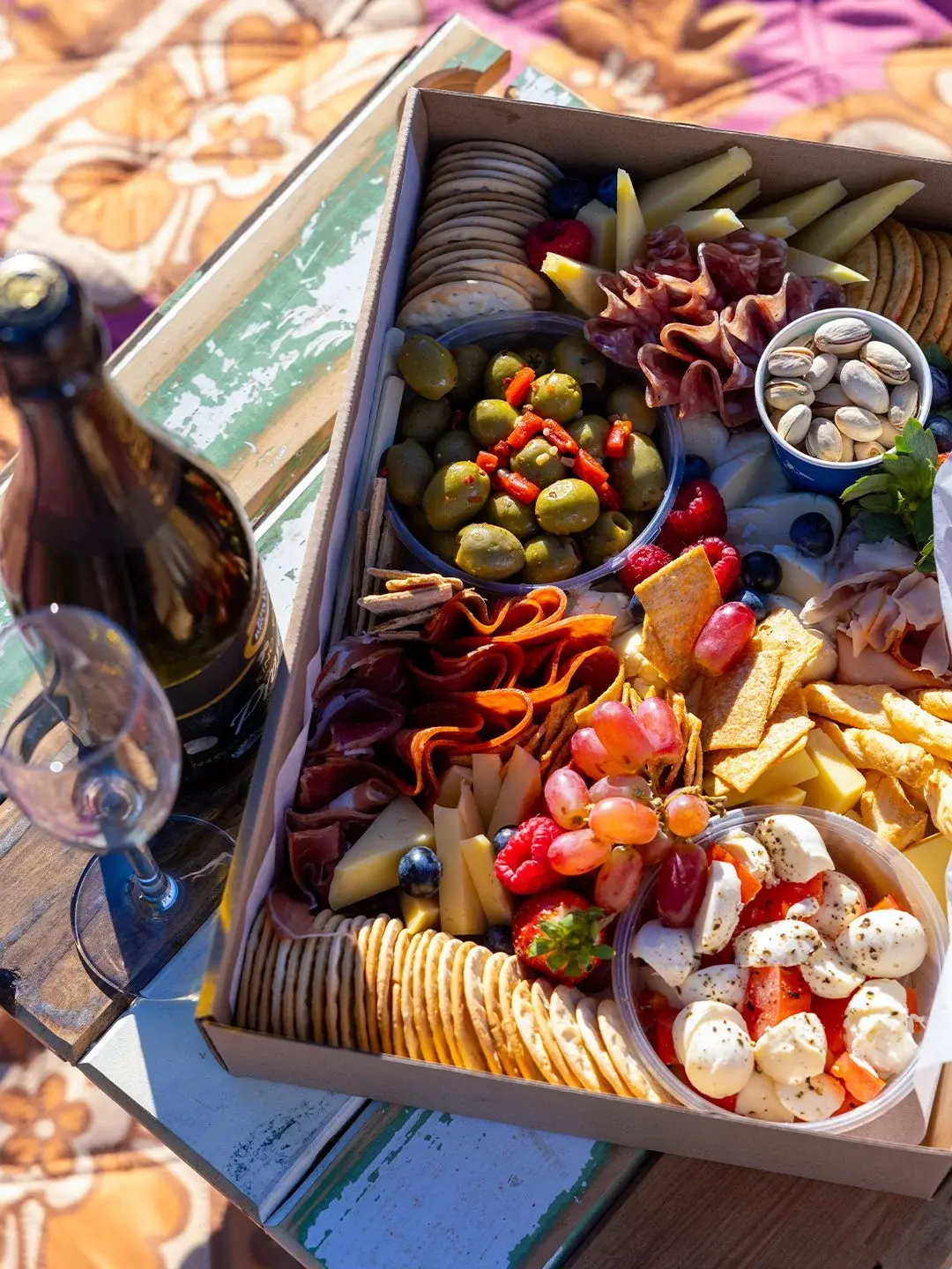 A savoury picnic box of cheeses, cured meats, olives and crackers